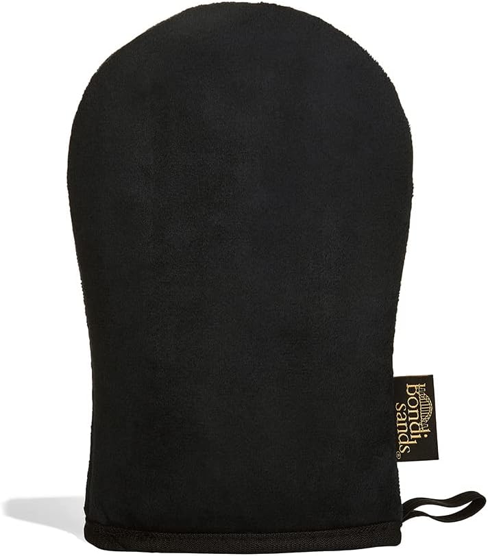 Bondi Sands self-tanning application mitt in black velvety fabric with a gold woven brand tag and a hanging loop