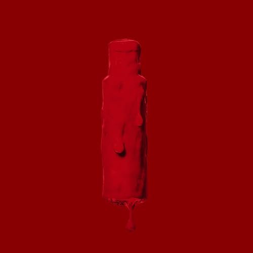 Crazy Color bottle completely coated in dripping vermillion red dye against a red background