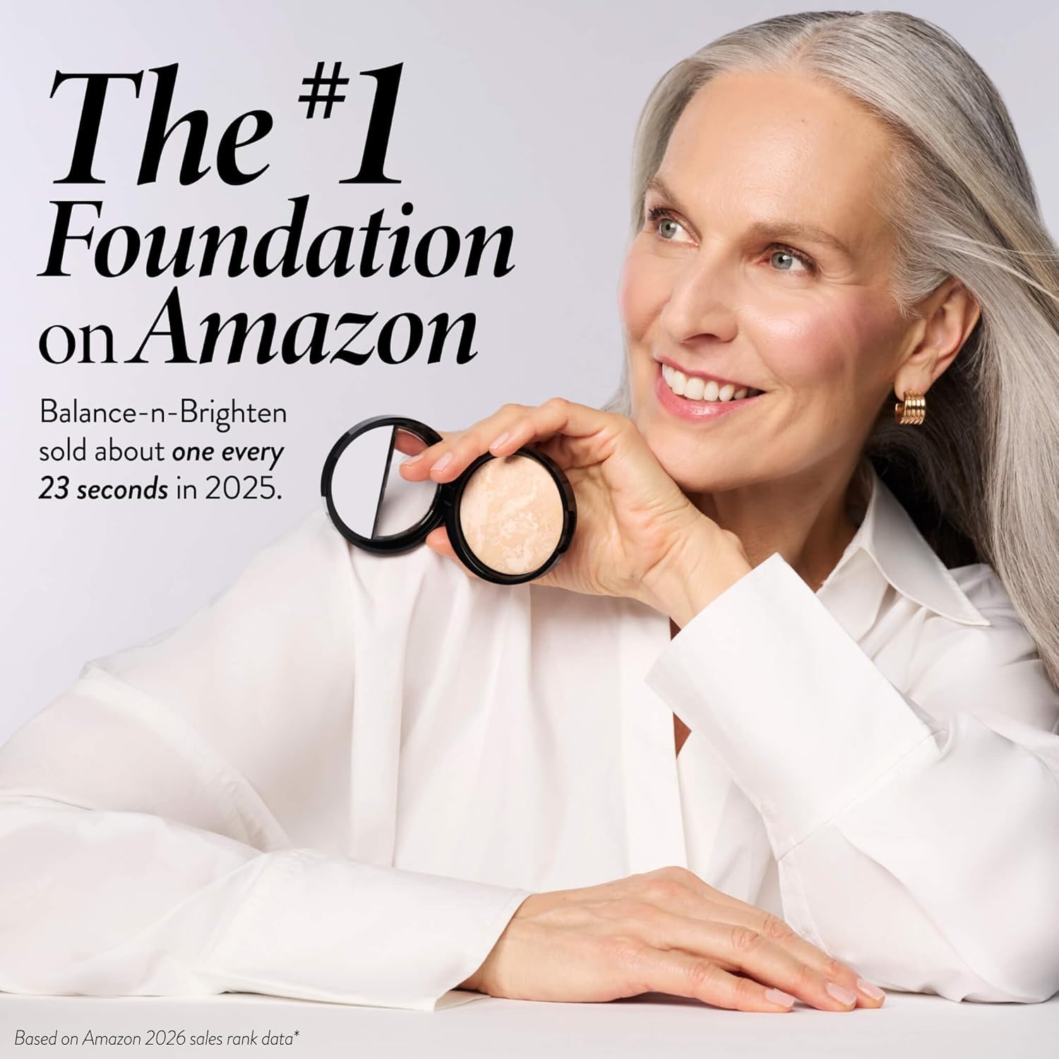 Compact tilted to show the dome of marbled powder catching the light