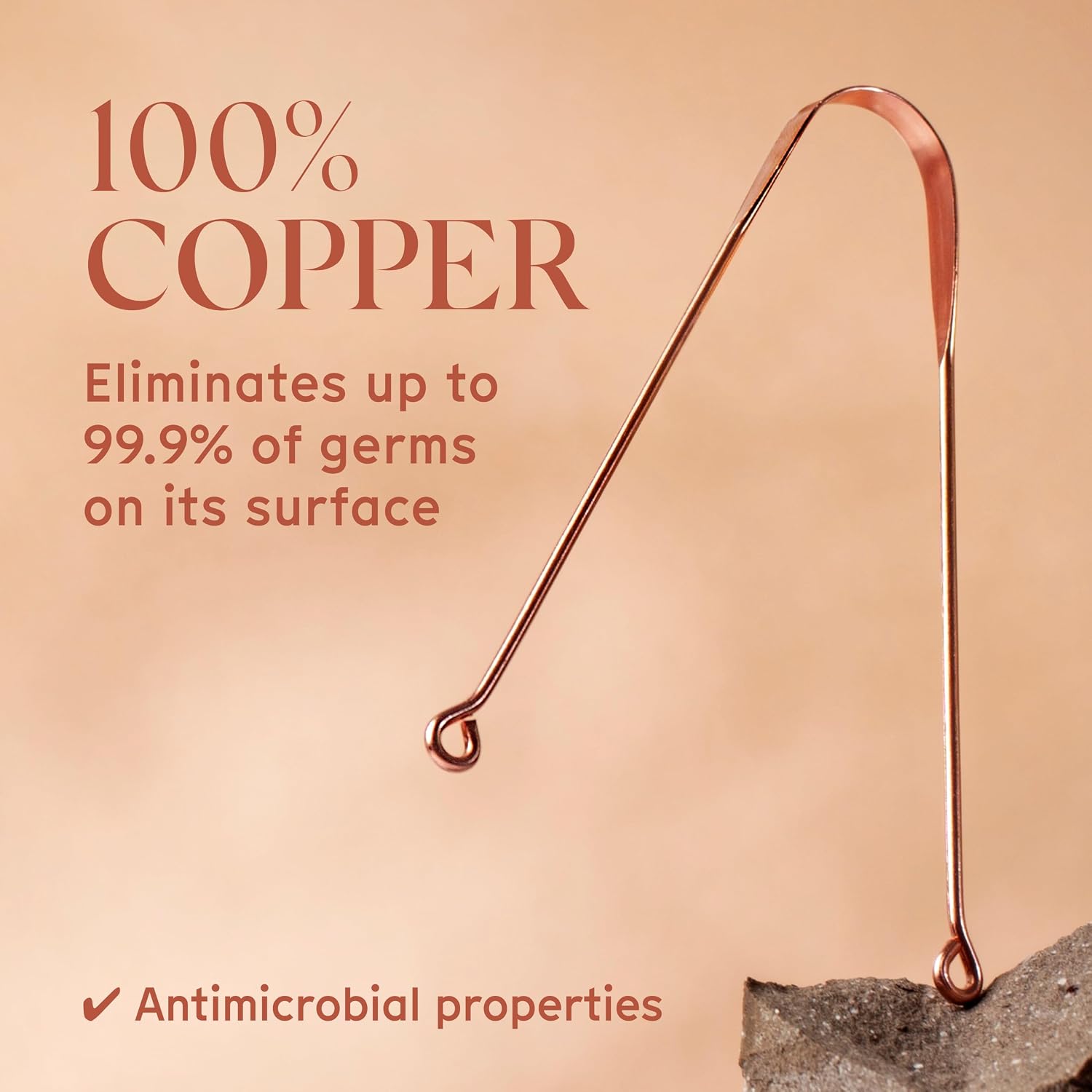 Close-up of the Arista copper tongue scraper with the listing claim that it eliminates up to 99.9 percent of germs on its surface and has antimicrobial properties