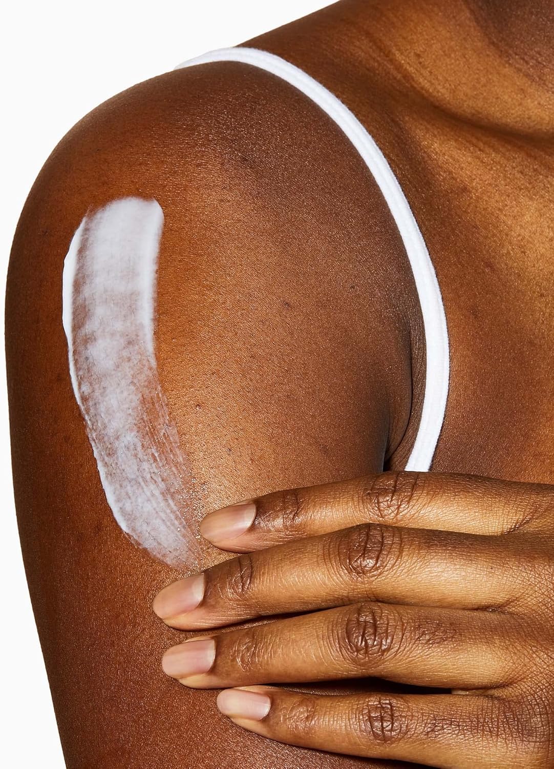 CeraVe Moisturising Cream being applied to shoulder showing lightweight texture