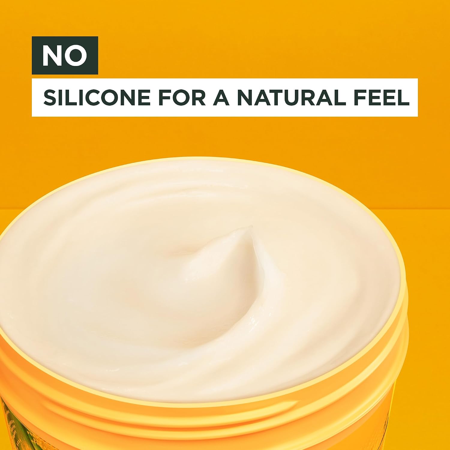 Open tub of Garnier Banana Hair Food showing the pale swirled cream with no silicone formula
