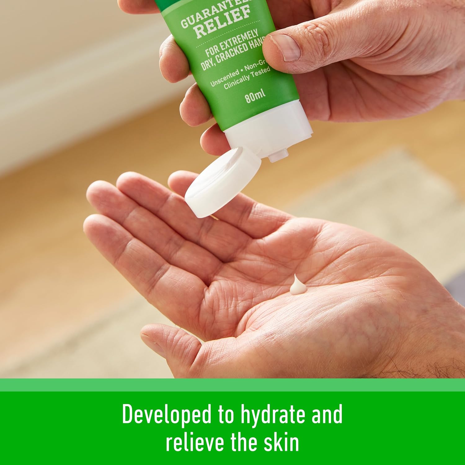 Close-up of O'Keeffe's Working Hands cream being squeezed from the tube into a palm