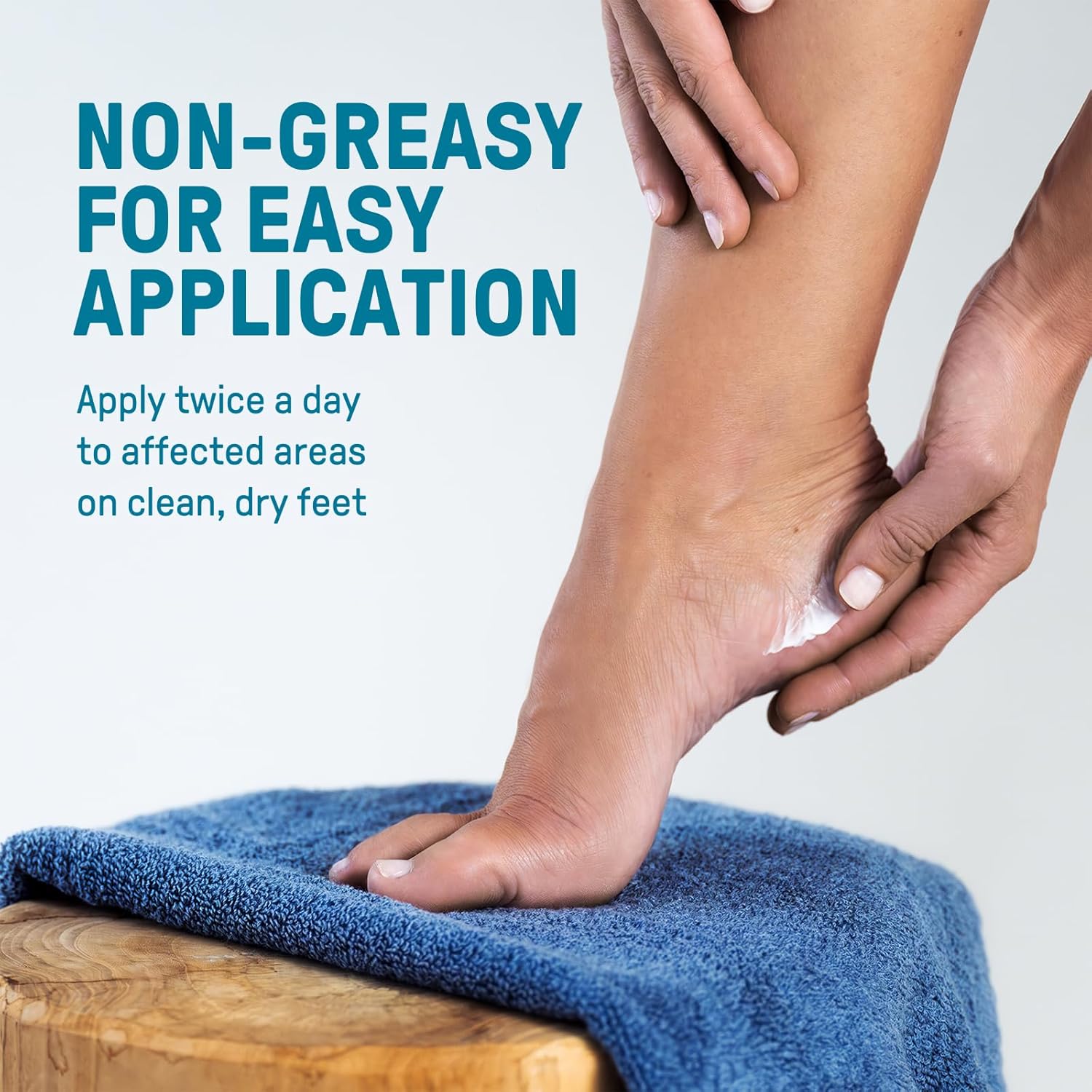 Hand applying CCS Foot Care Cream to a heel on a blue towel, with the listing's non-greasy for easy application claim and twice-a-day directions