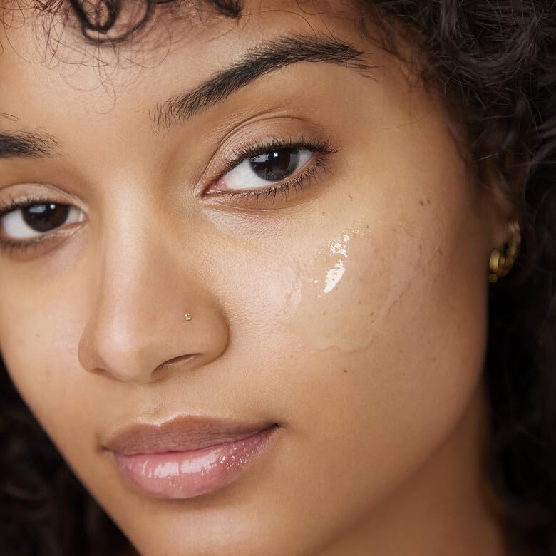 Model with a swipe of clear Power Grip Primer gel applied to her cheek before blending