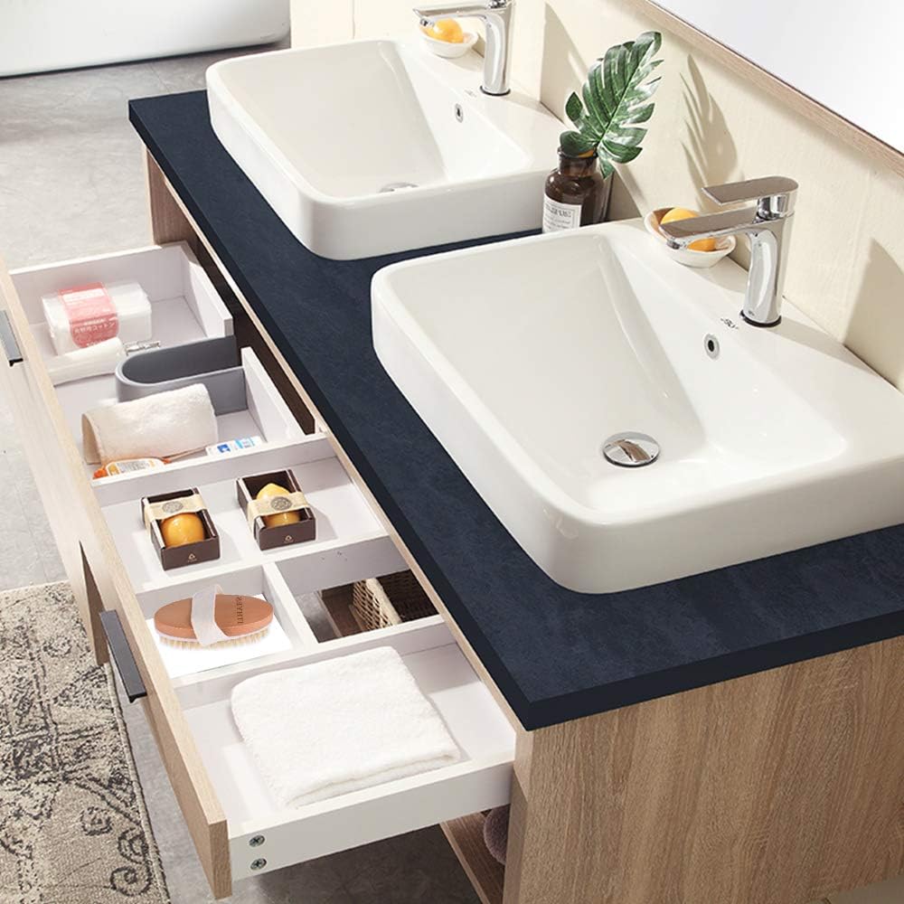 The Ithyes body brush stored in a bathroom vanity drawer alongside folded towels and toiletries