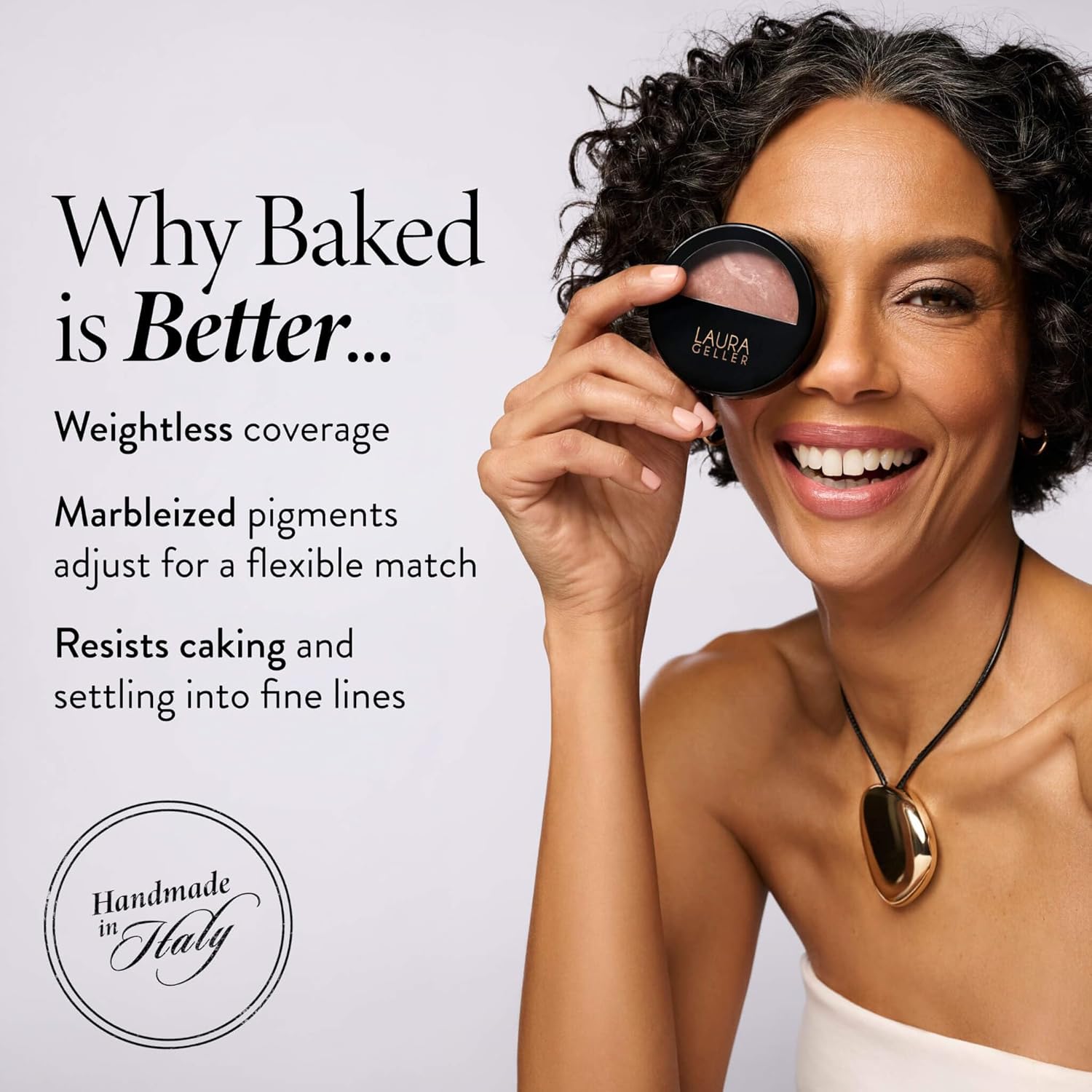 Hand holding a kabuki brush above the open powder compact