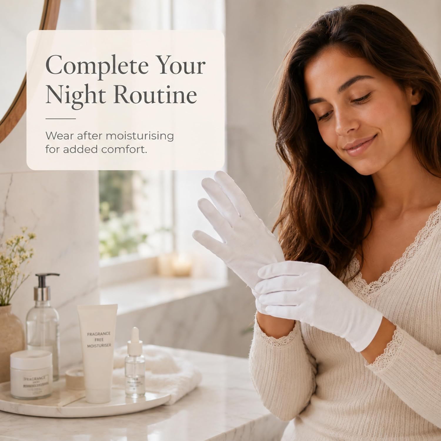 Woman pulling on a white cotton moisturising glove after her evening skincare routine