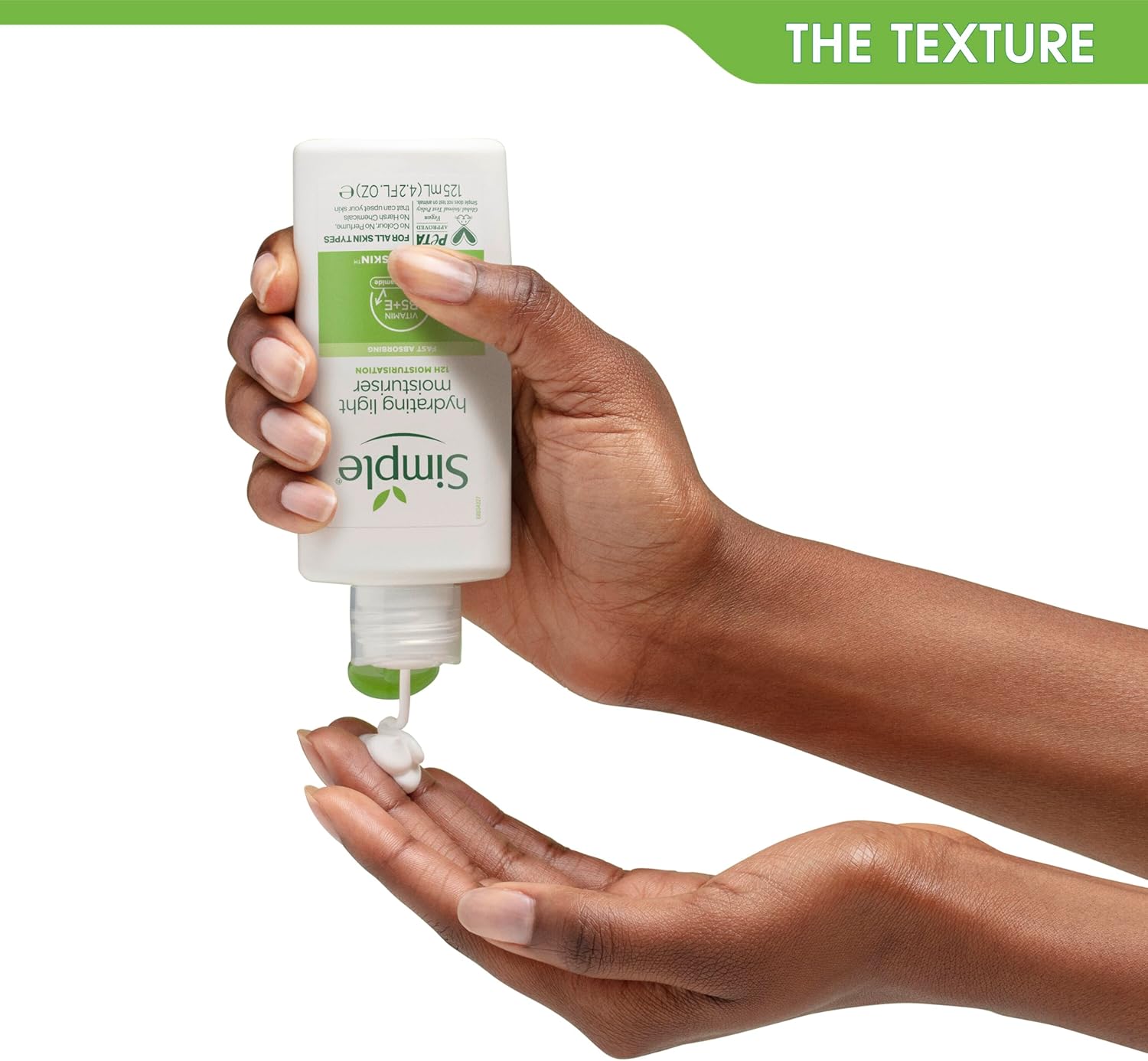 Hand squeezing Simple Hydrating Light Moisturiser from the 125ml bottle to show the light cream texture