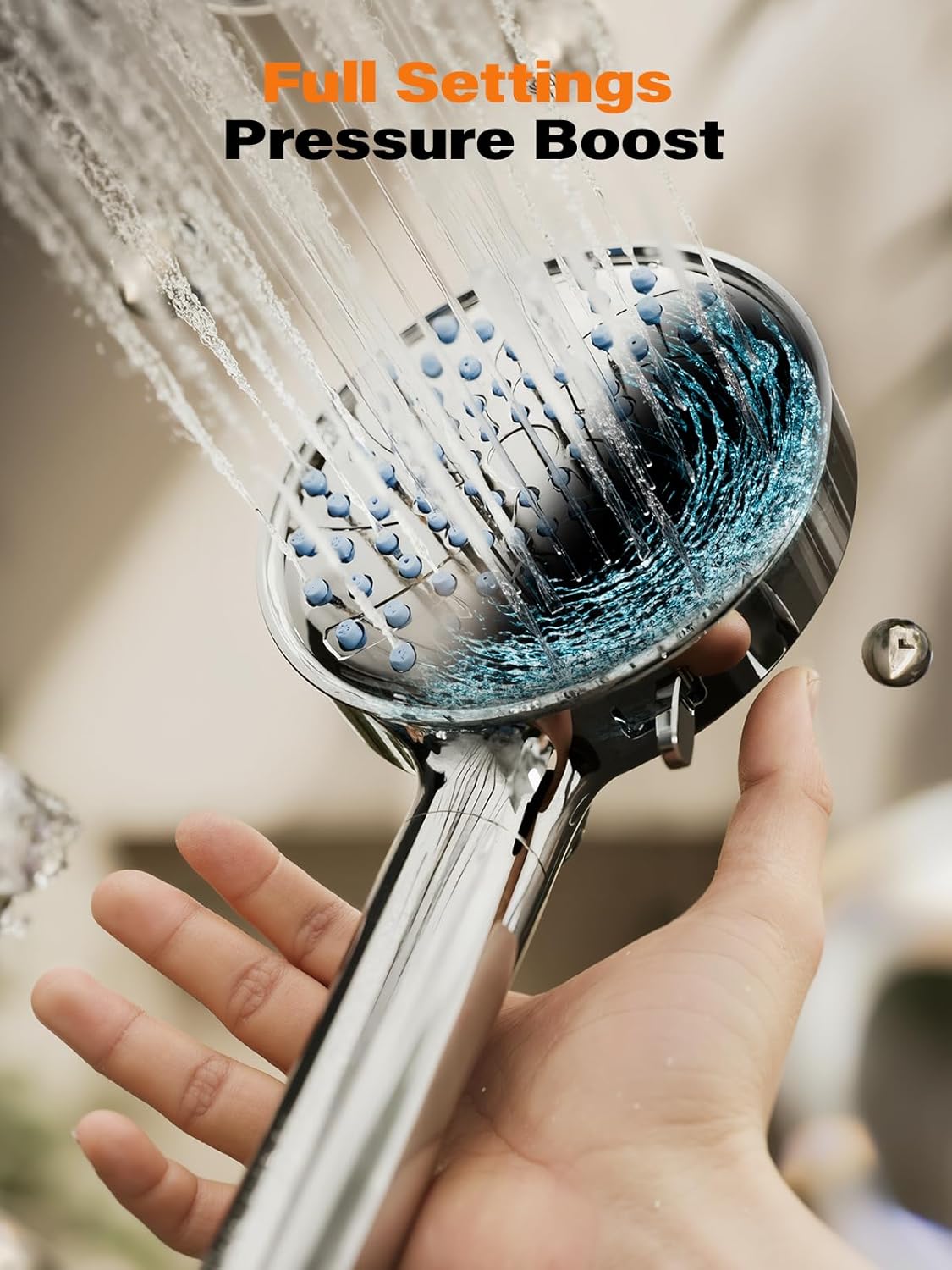 Water jets firing from the Cobbe shower head face while a hand holds it on the pressure boost setting