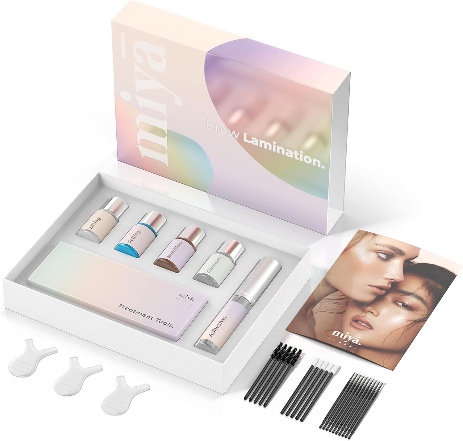 Opened MIYA LASH box showing four treatment bottles, adhesive wand, treatment tools case, instruction manual, Y-combs and rows of disposable brushes laid out
