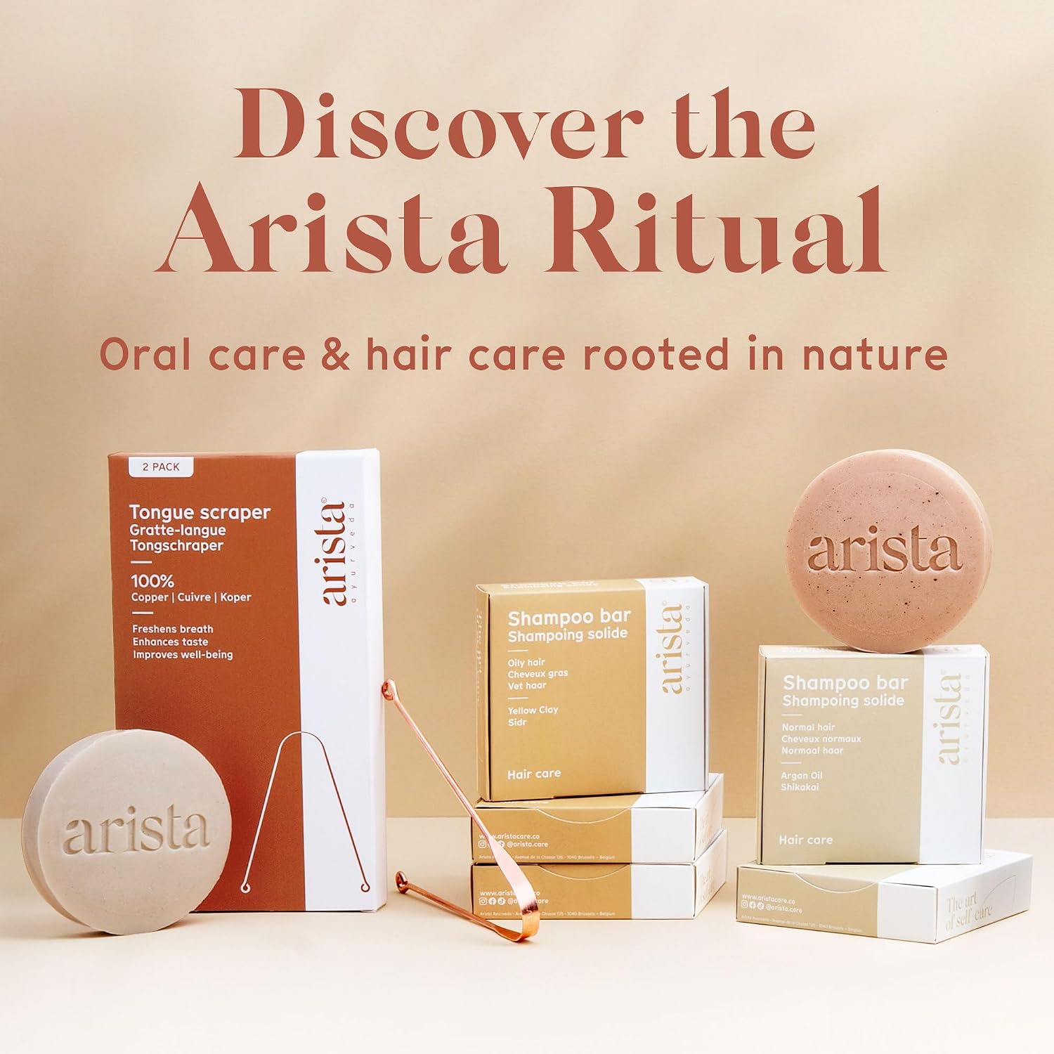 The Arista tongue scraper box shown beside Arista shampoo bars under a Discover the Arista Ritual banner; the shampoo bars are separate products and are not included with the tongue scraper 2 pack
