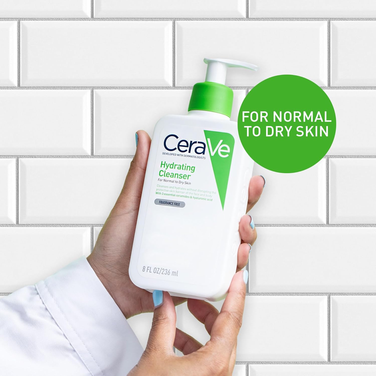 Hand holding CeraVe Hydrating Cleanser bottle in a bathroom setting