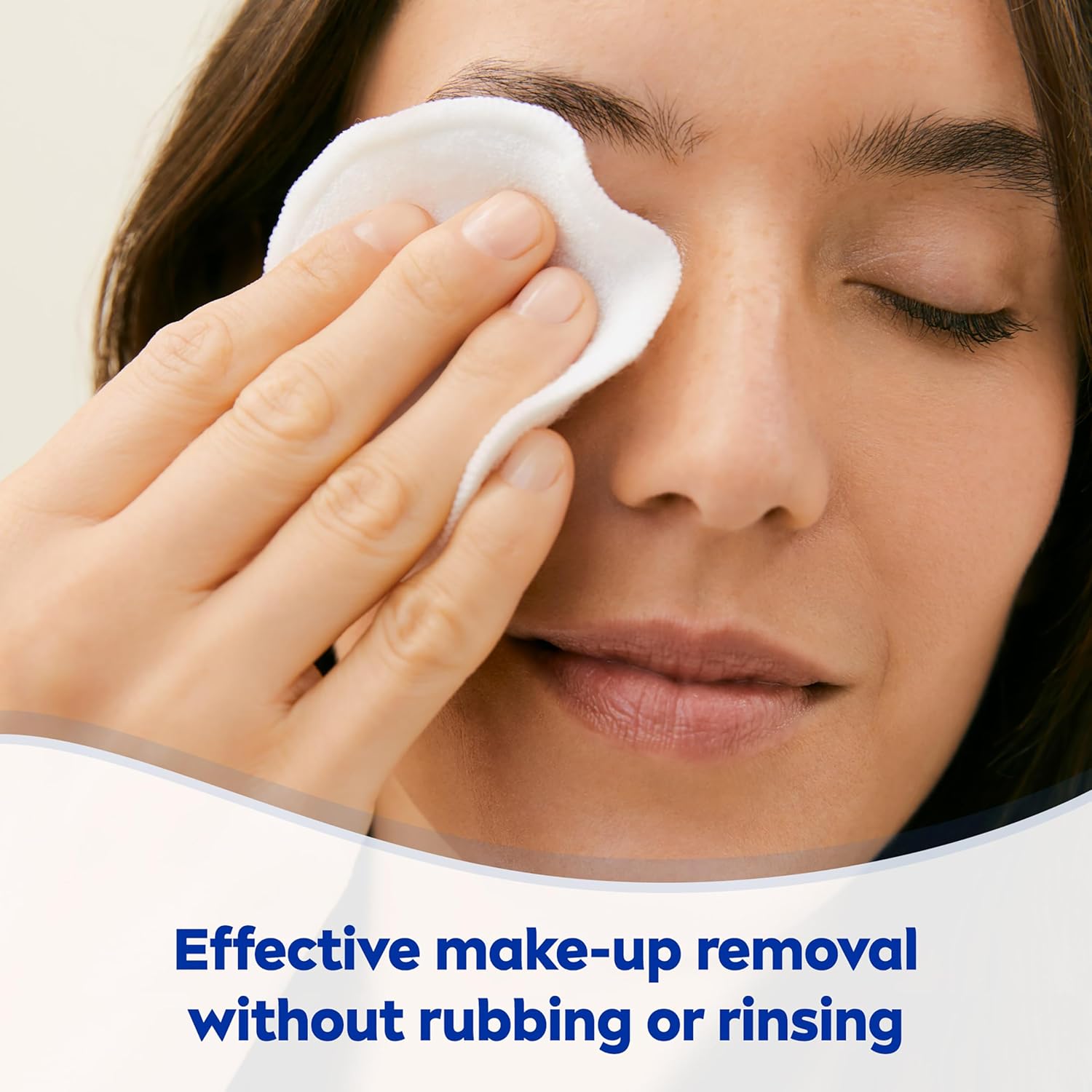 Woman applying NIVEA eye makeup remover with cotton pad