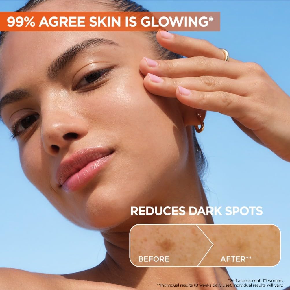 Woman with glowing radiant skin showing before and after dark spot reduction results from using Garnier Vitamin C Serum