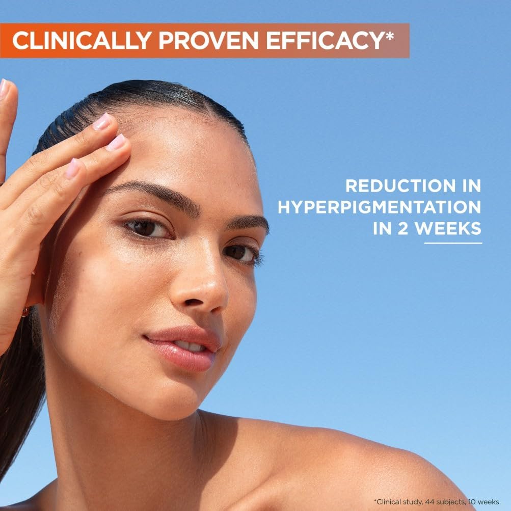 Woman with clear, even-toned skin demonstrating the results of consistent Vitamin C serum use with text overlay about hyperpigmentation reduction in 2 weeks
