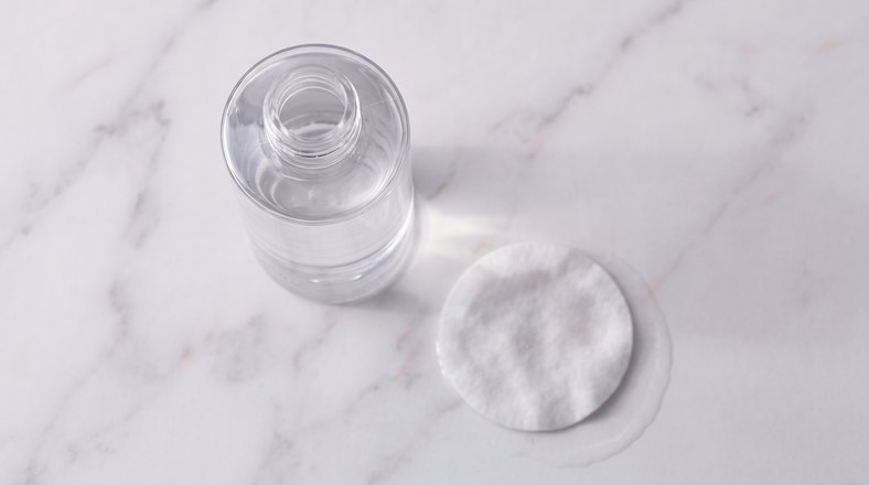 Hydrating toner and cotton pad, the toning step in the correct skincare layering order