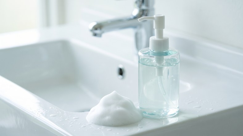 Salicylic acid face wash and foam beside a basin for twice-daily cleansing against nose blackheads
