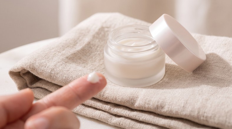 Eye cream on a fingertip, the dedicated eye care step in the skincare layering order